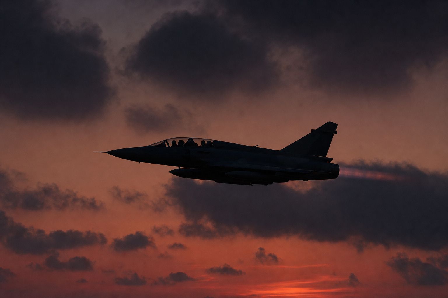 Military aircraft silhouetted against a dusk sky